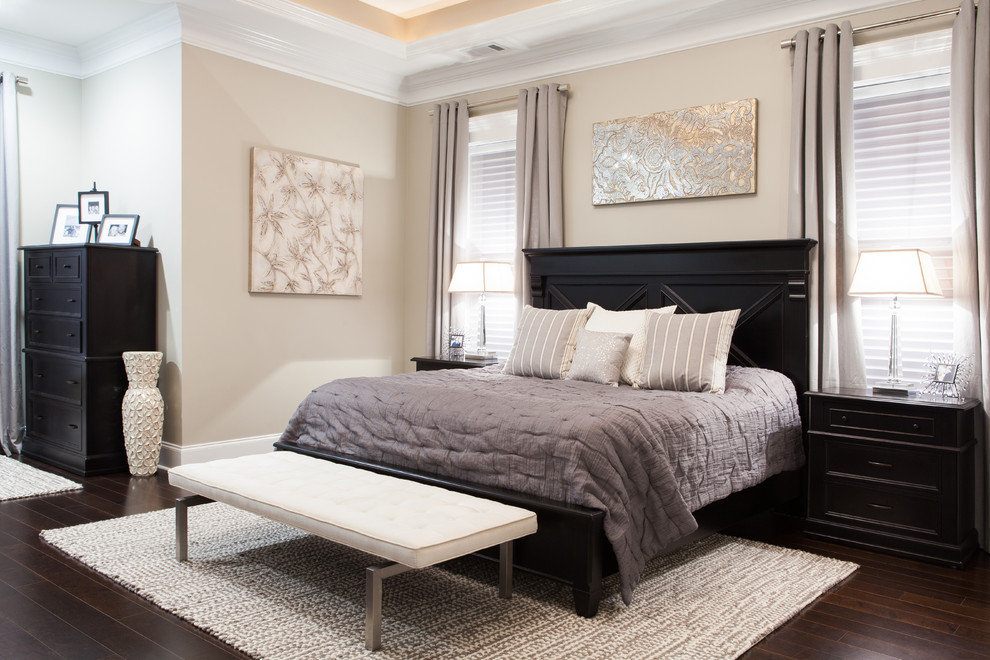 This is an example of a classic cream and black bedroom in Charleston with beige walls.