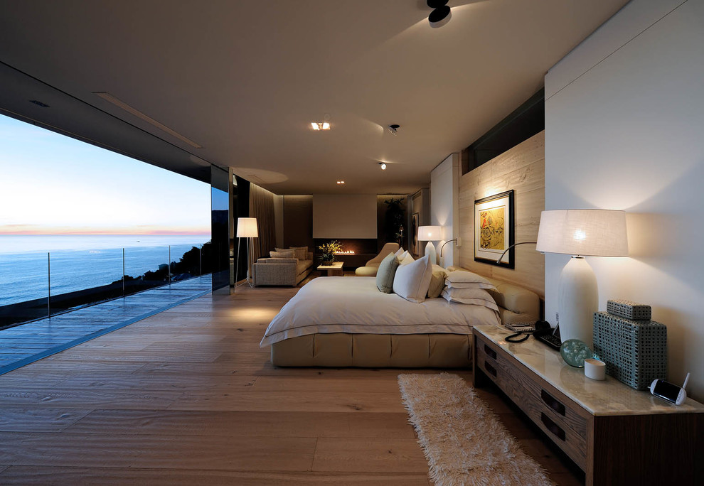 Photo of a contemporary bedroom in Other with white walls and feature lighting.
