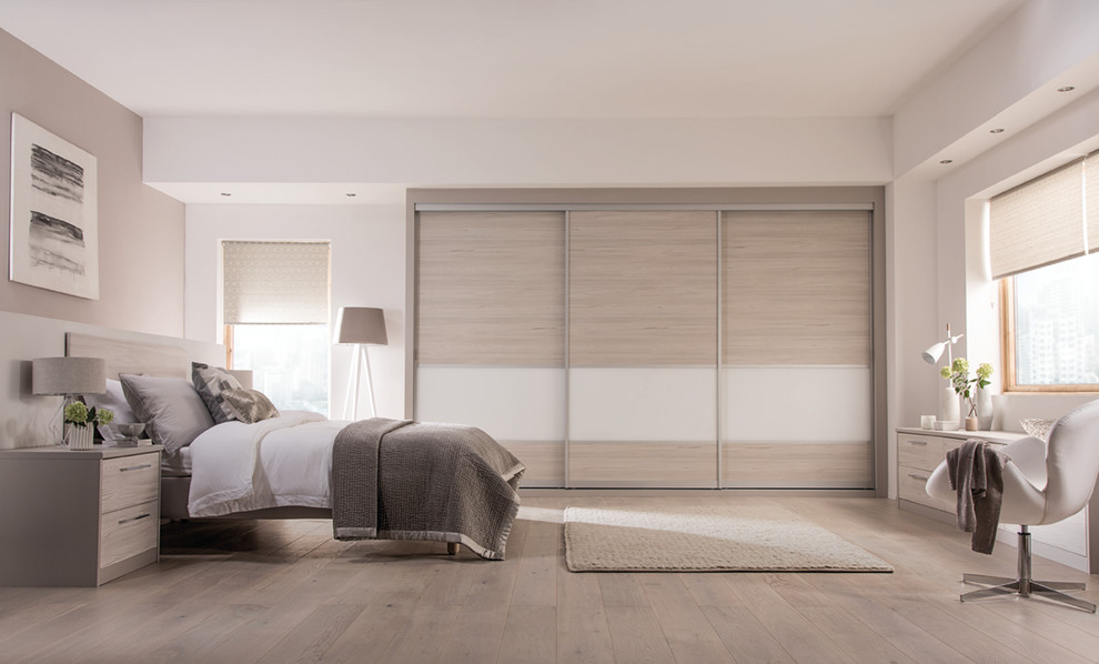 Inspiration for a contemporary bedroom in West Midlands with light hardwood flooring.