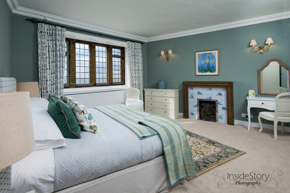 This is an example of a medium sized traditional guest bedroom in Other with green walls, carpet, a standard fireplace and a tiled fireplace surround.