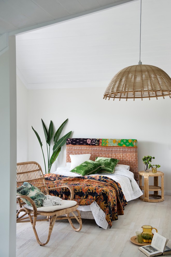 Inspiration for a tropical guest light wood floor bedroom remodel in Perth with white walls and no fireplace