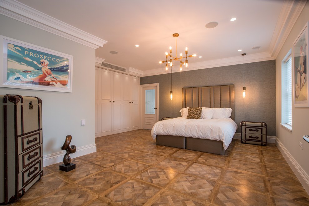 Bedroom - transitional master medium tone wood floor and brown floor bedroom idea in Buckinghamshire with gray walls