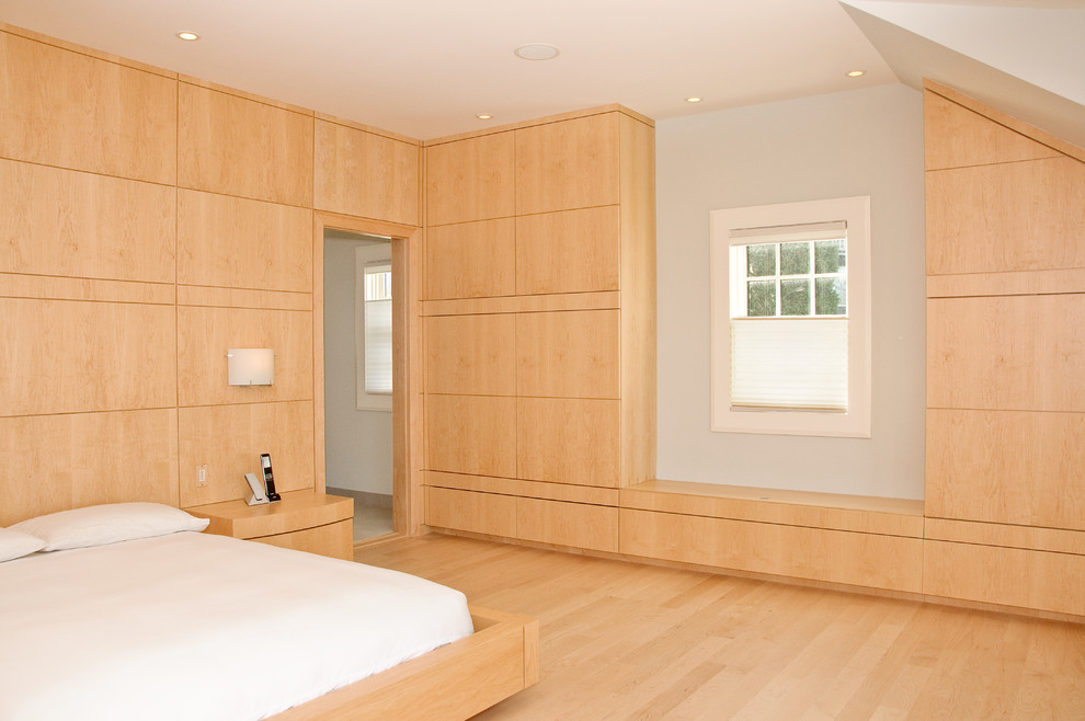 Minimalist light wood floor bedroom photo in Portland Maine with white walls and no fireplace