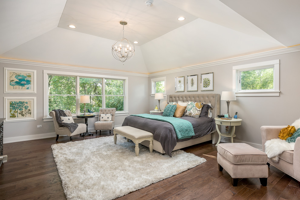 Traditional grey and brown bedroom in Chicago with beige walls, dark hardwood flooring and brown floors.