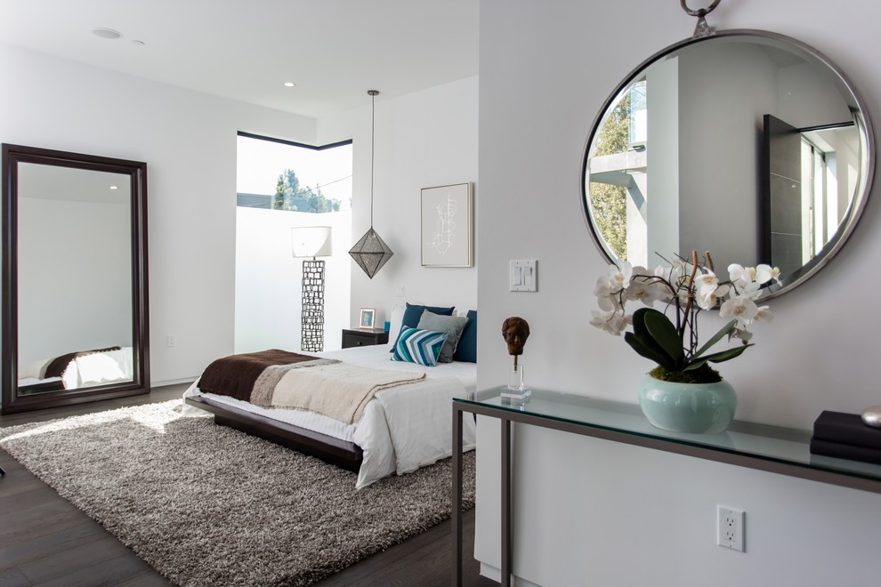 Design ideas for a contemporary grey and brown bedroom in Los Angeles with white walls, dark hardwood flooring and brown floors.