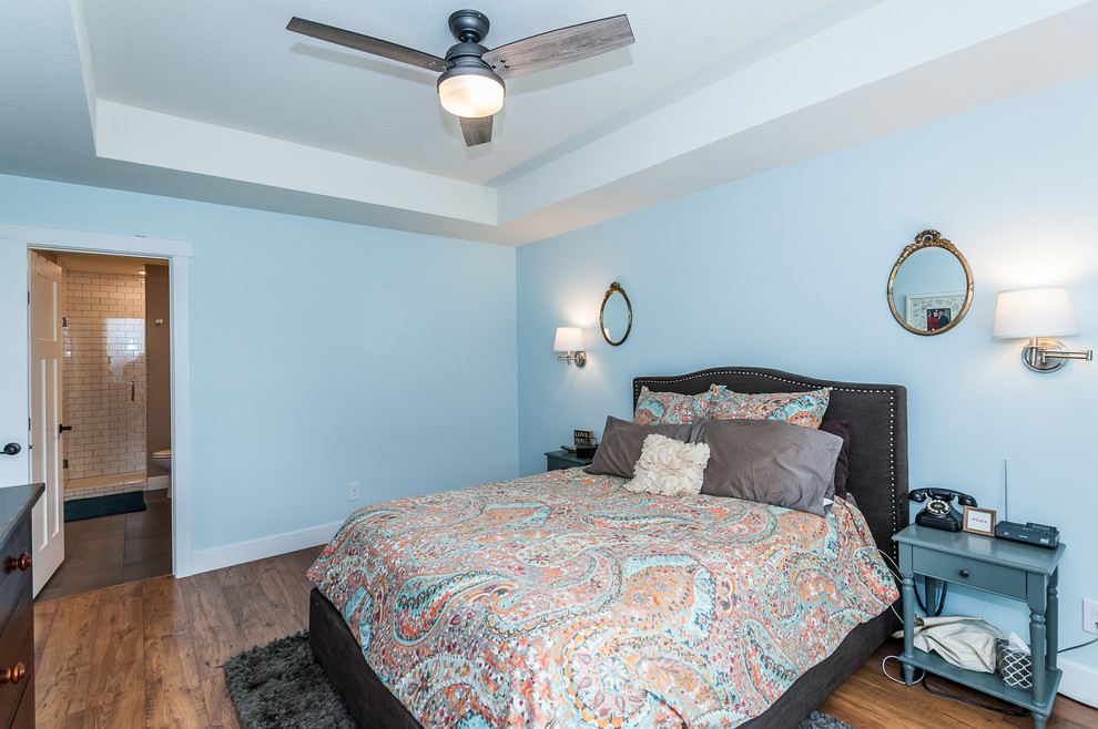 This is an example of a medium sized traditional bedroom in Other with blue walls, dark hardwood flooring and brown floors.