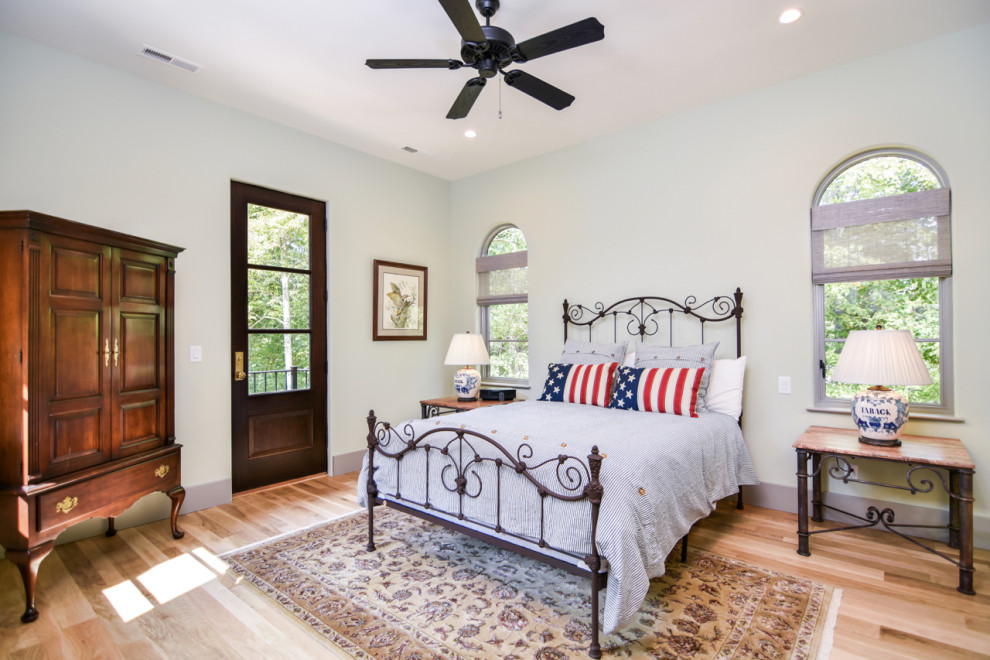 Mid-sized tuscan master light wood floor and beige floor bedroom photo in Other with white walls and no fireplace