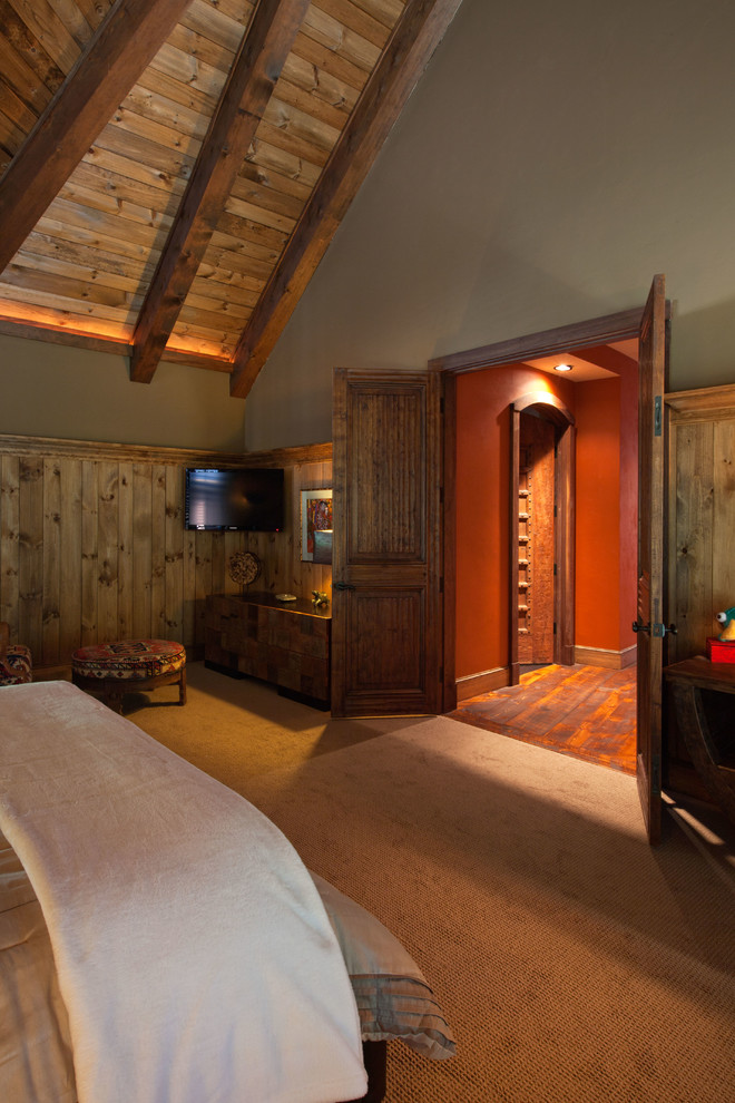 Inspiration for a large rustic master bedroom in Burlington with beige walls and carpet.