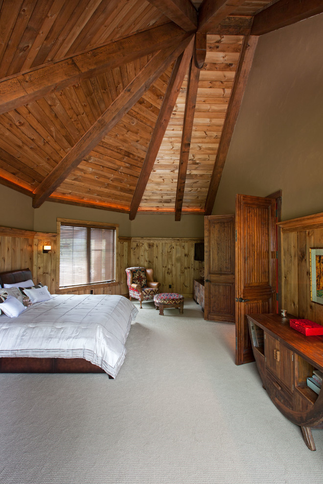 Inspiration for a large rustic master carpeted bedroom remodel in Burlington with beige walls