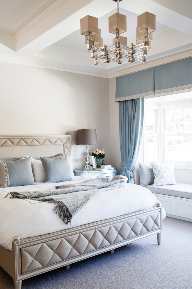 This is an example of a medium sized traditional grey and cream bedroom in Brisbane with white walls and carpet.