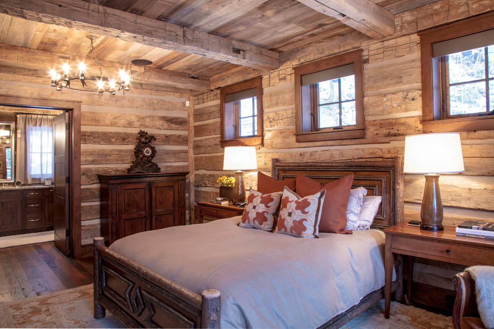 Photo of a large rustic master bedroom in Boston with dark hardwood flooring.