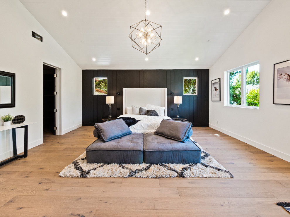 Bedroom - large farmhouse master vaulted ceiling and wall paneling bedroom idea in Los Angeles