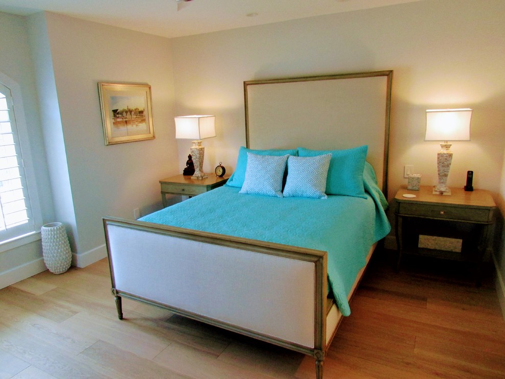 Example of a mid-sized beach style guest light wood floor and beige floor bedroom design in Miami with gray walls and no fireplace
