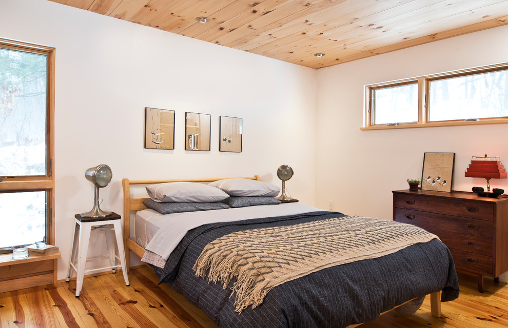 Ejemplo de dormitorio de estilo de casa de campo con paredes blancas y suelo de madera en tonos medios