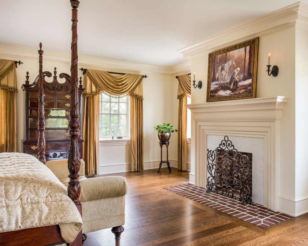 Inspiration for a timeless master dark wood floor bedroom remodel in Philadelphia with beige walls, a standard fireplace and a stone fireplace