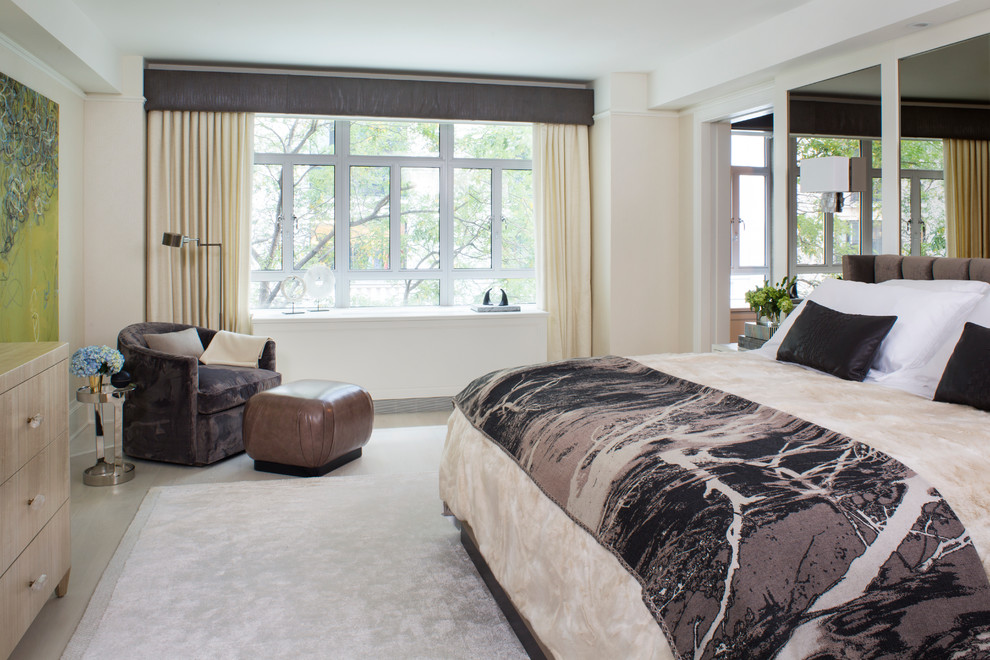 This is an example of a medium sized contemporary master bedroom in New York with white walls, light hardwood flooring and no fireplace.