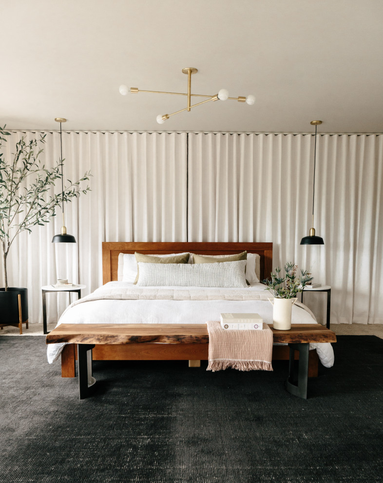 Photo of a large modern master bedroom in Seattle with grey walls, carpet, a two-sided fireplace, a tiled fireplace surround and beige floors.