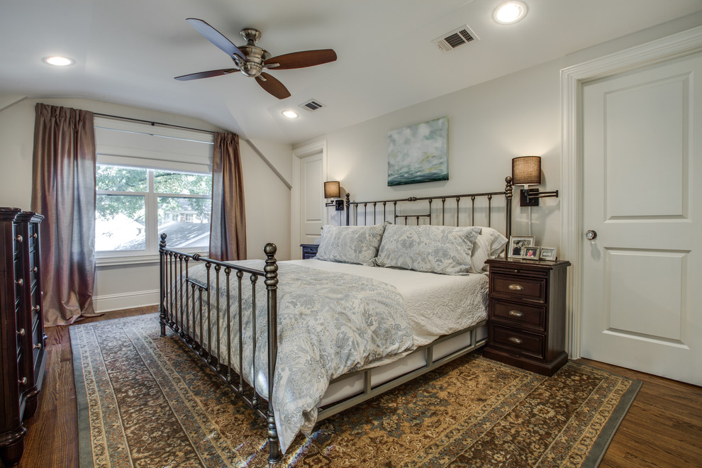 This is an example of a medium sized traditional master bedroom in Dallas with white walls, medium hardwood flooring and no fireplace.