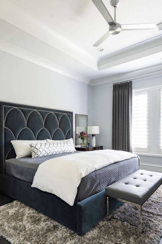 Inspiration for a large mediterranean guest dark wood floor and black floor bedroom remodel in Dallas with white walls