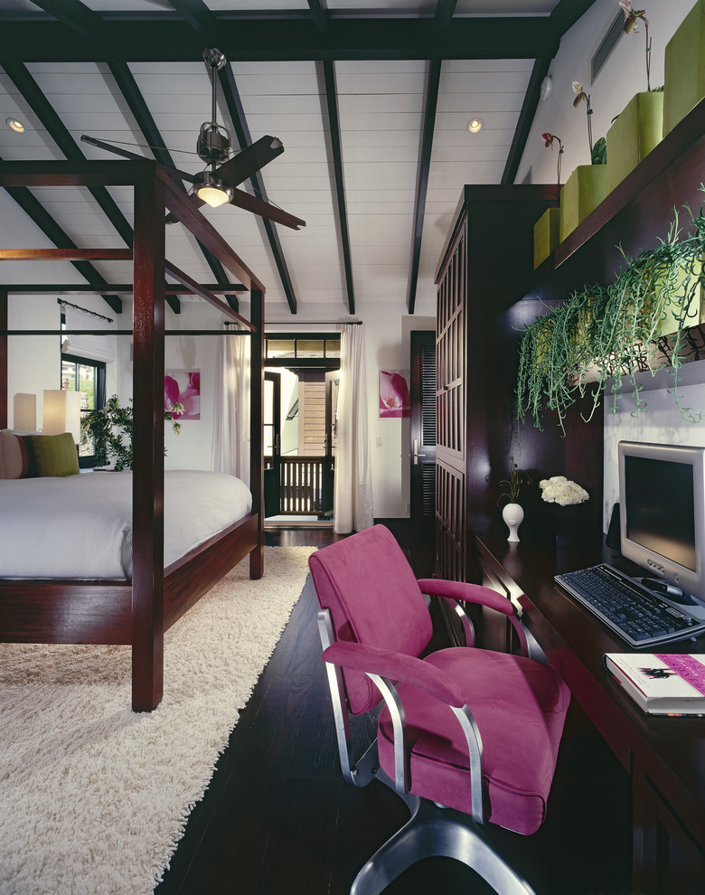 Example of an island style bedroom design in Orange County with white walls