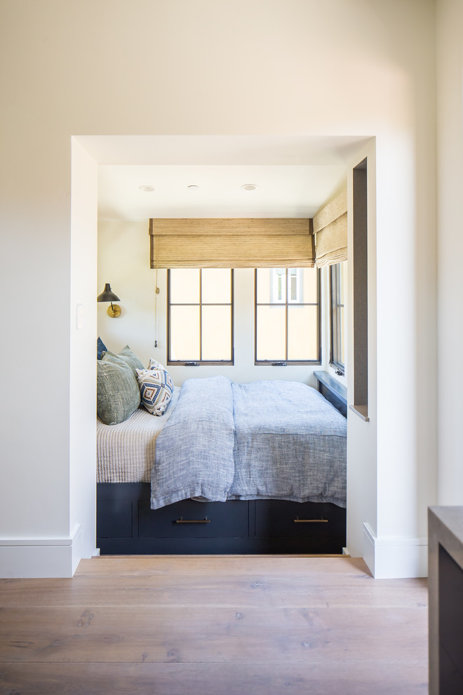 Bedroom - large mediterranean guest medium tone wood floor and brown floor bedroom idea in Orange County with white walls