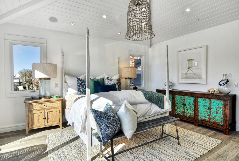 Design ideas for an eclectic bedroom in Orange County with light hardwood flooring.