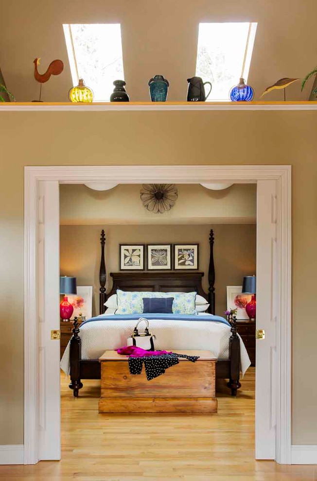 Elegant light wood floor bedroom photo in Providence with beige walls