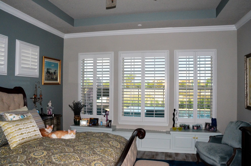 Photo of a large traditional master bedroom in Orlando with grey walls and porcelain flooring.