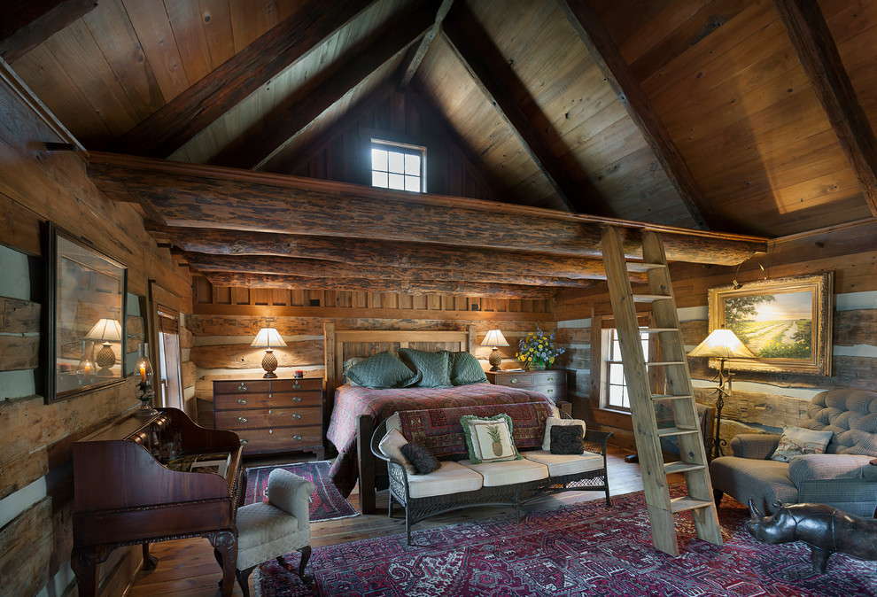 Design ideas for a large rustic master loft bedroom in Charleston with medium hardwood flooring and no fireplace.