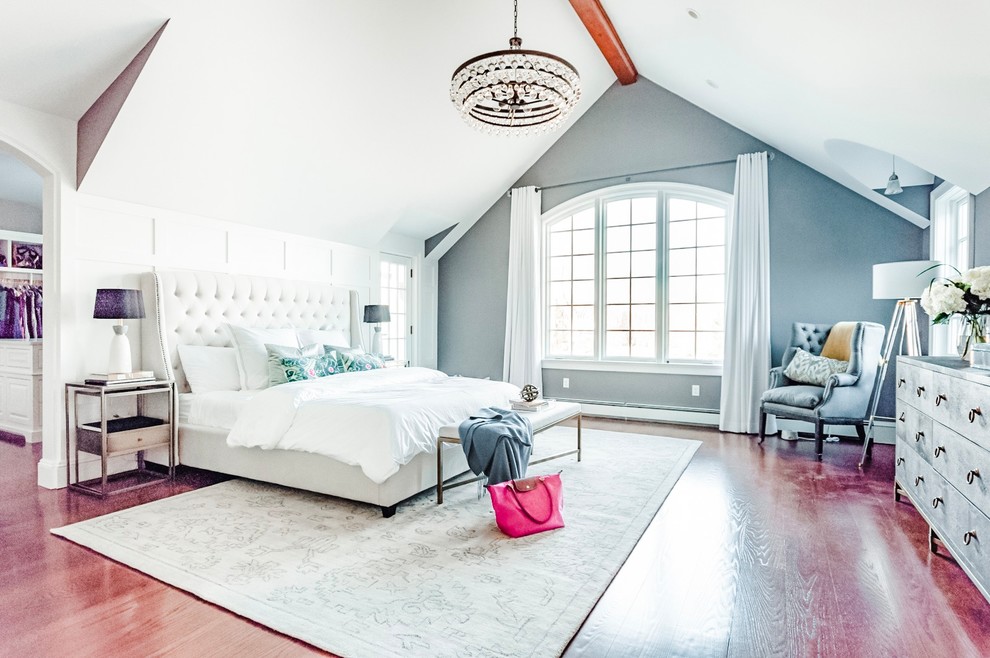 Inspiration for a large traditional master bedroom in Newark with medium hardwood flooring, a standard fireplace, a brick fireplace surround, brown floors and grey walls.