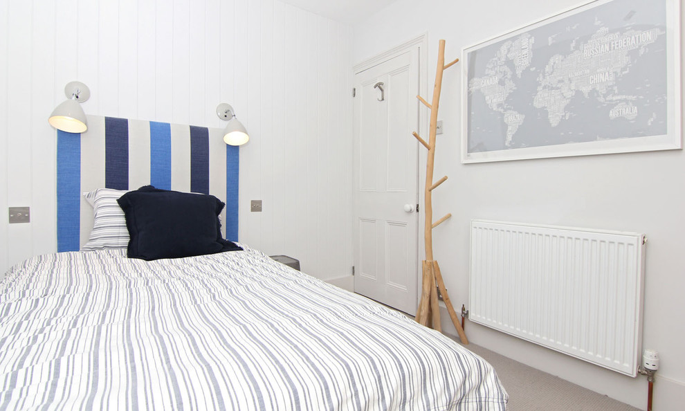 Small nautical guest bedroom in Cornwall with white walls, carpet and no fireplace.