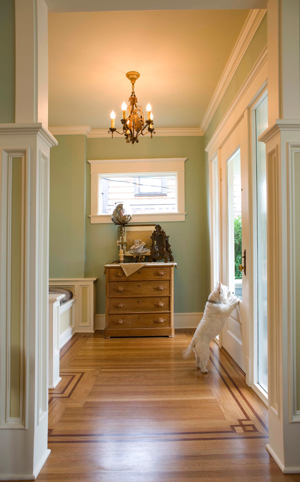 Example of a large classic guest light wood floor bedroom design in Seattle with green walls and no fireplace