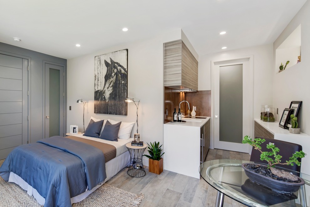 Ispirazione per una camera da letto contemporanea con pareti bianche e pavimento grigio