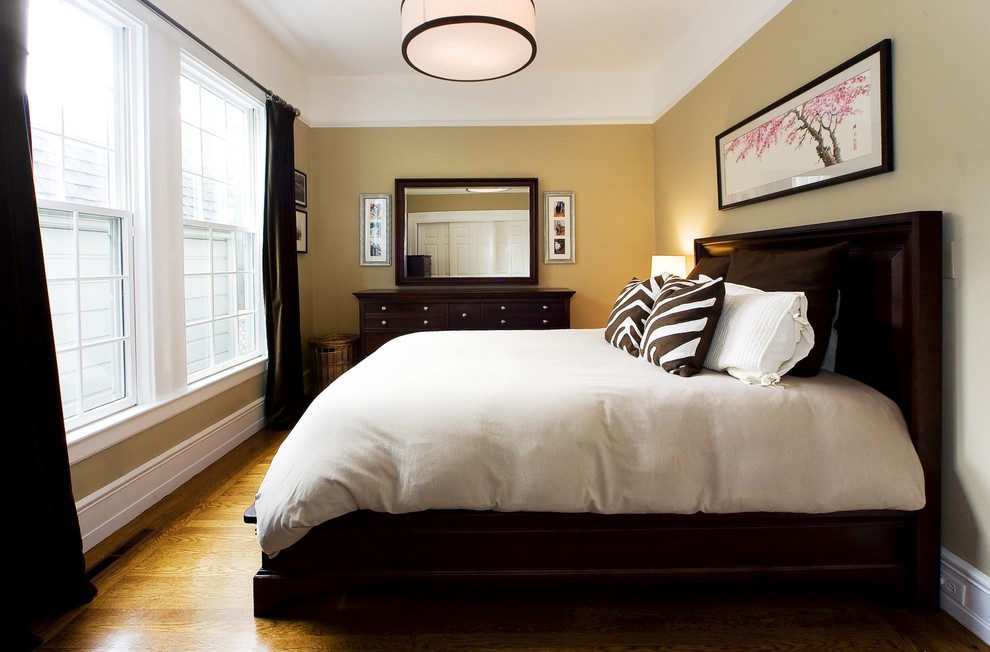 Trendy medium tone wood floor bedroom photo in San Francisco with beige walls and no fireplace