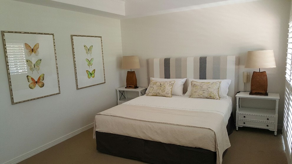 Design ideas for a medium sized traditional master bedroom in Sunshine Coast with carpet, beige floors and white walls.