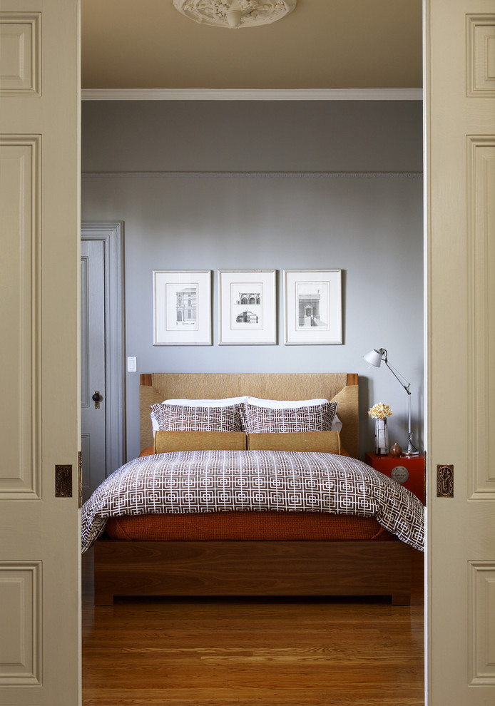 Foto de dormitorio beige tradicional renovado con paredes grises, suelo de madera en tonos medios y suelo beige