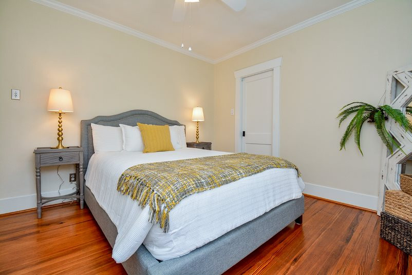 Design ideas for a traditional grey and yellow bedroom in Houston.