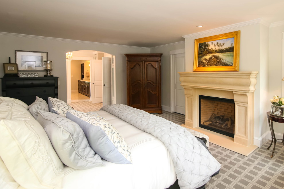 Inspiration for a timeless carpeted bedroom remodel in DC Metro with beige walls, a standard fireplace and a plaster fireplace