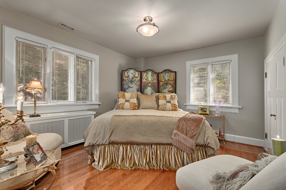 Medium sized classic guest bedroom in Other with beige walls and medium hardwood flooring.