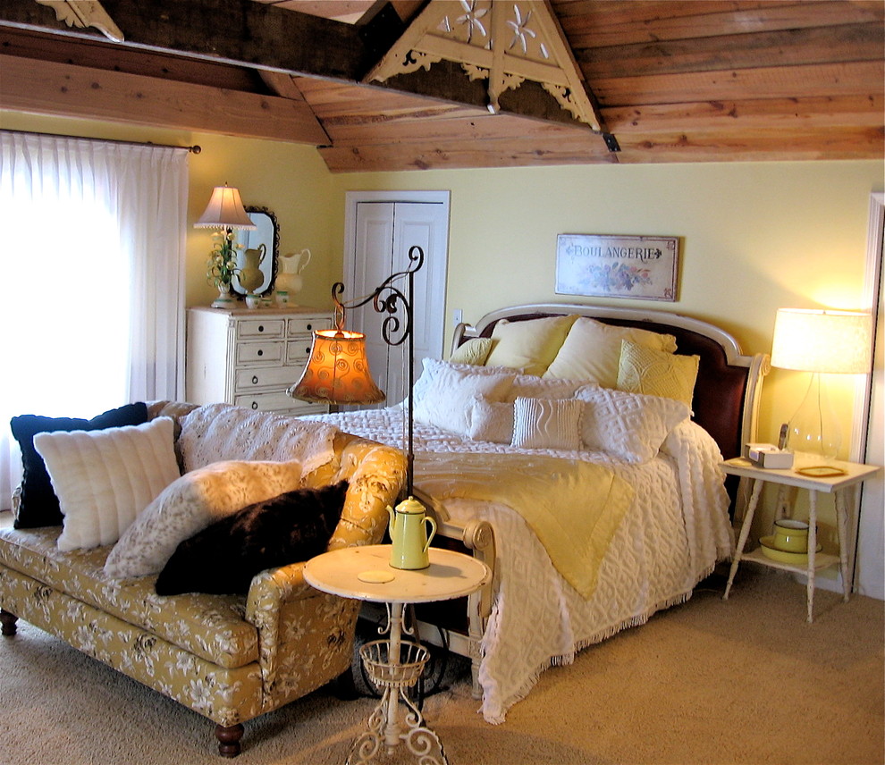 Inspiration for a mid-sized timeless guest carpeted bedroom remodel in Charlotte with yellow walls and no fireplace