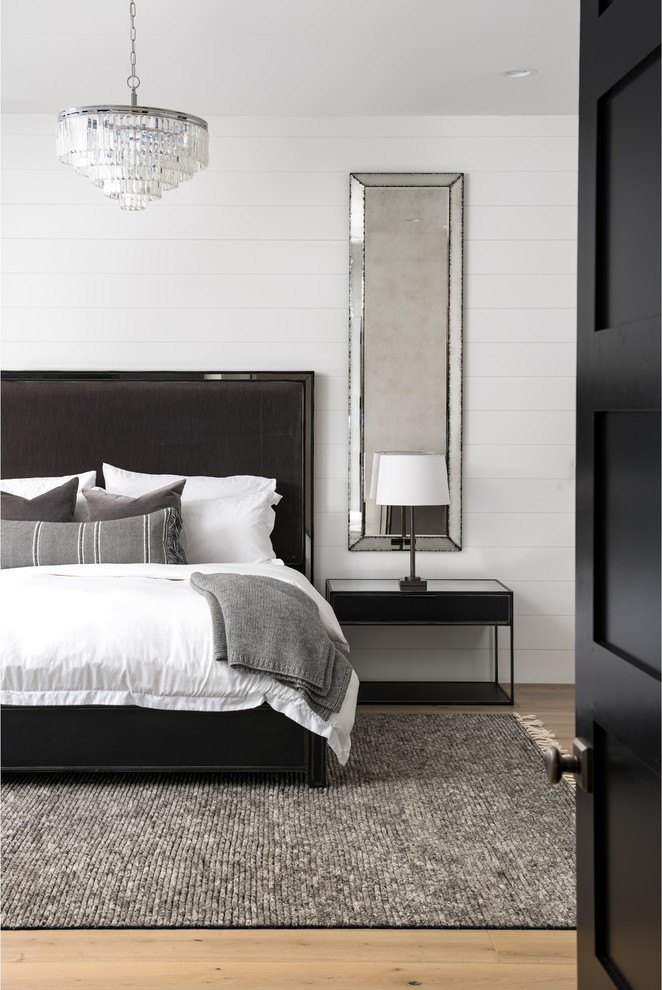 Design ideas for a traditional grey and black bedroom in Phoenix with white walls, light hardwood flooring and beige floors.