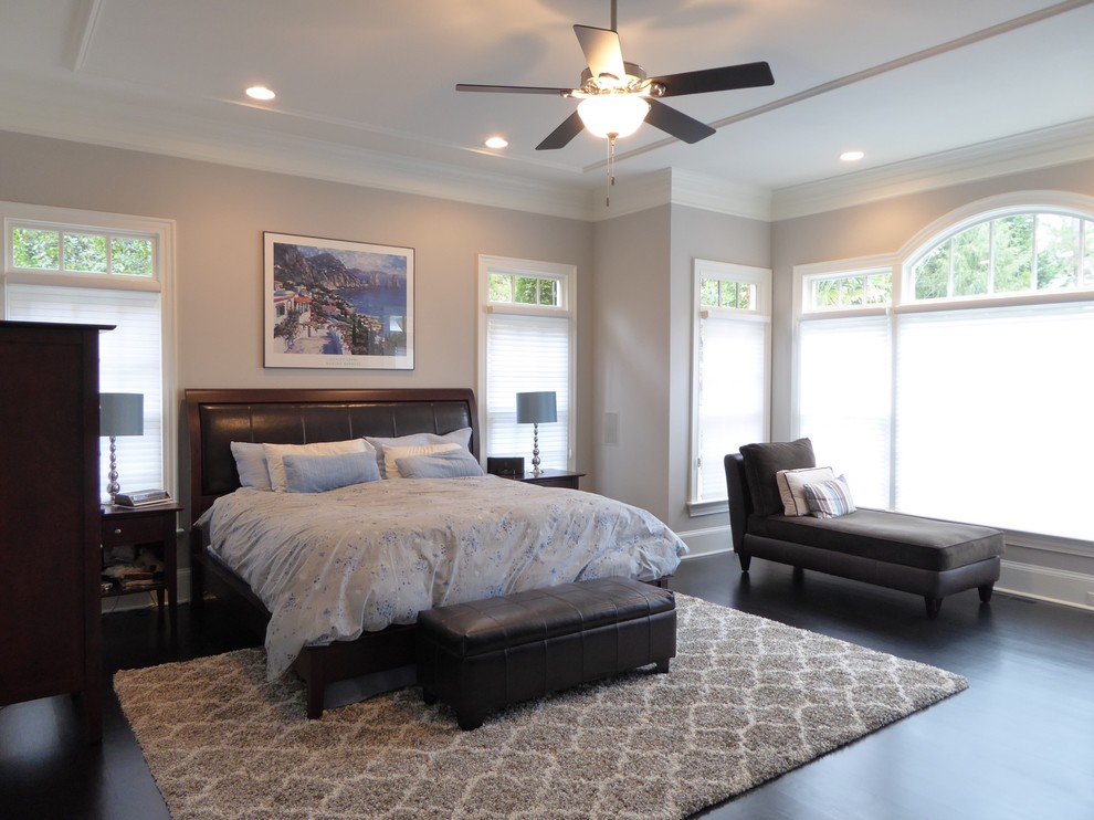 Design ideas for a large traditional master bedroom in Raleigh with grey walls, dark hardwood flooring, no fireplace and brown floors.