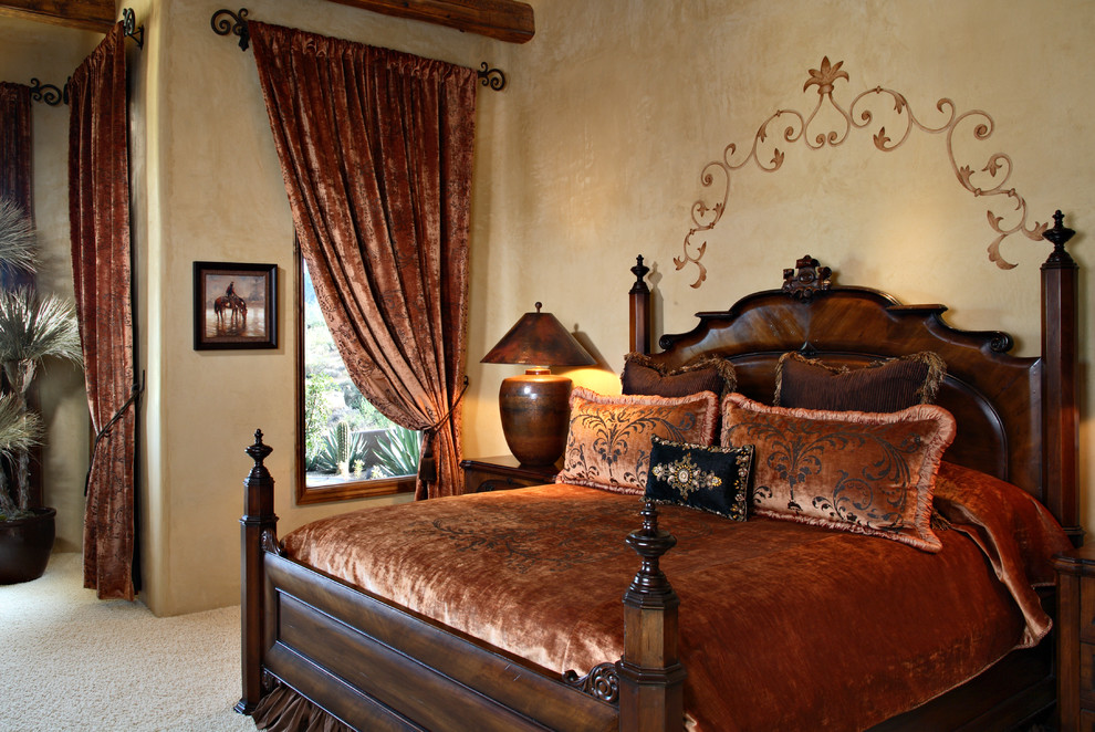 Photo of a large mediterranean master bedroom in Phoenix with beige walls, carpet, beige floors and no fireplace.