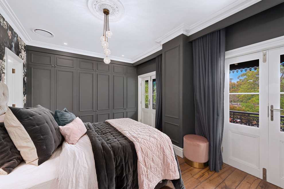 Photo of a traditional grey and brown bedroom in Sydney with grey walls, medium hardwood flooring and brown floors.