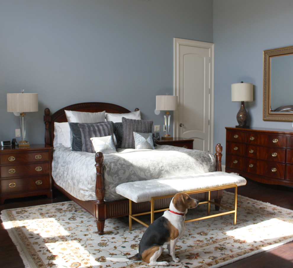 Photo of a large classic master bedroom in Chicago with blue walls and medium hardwood flooring.