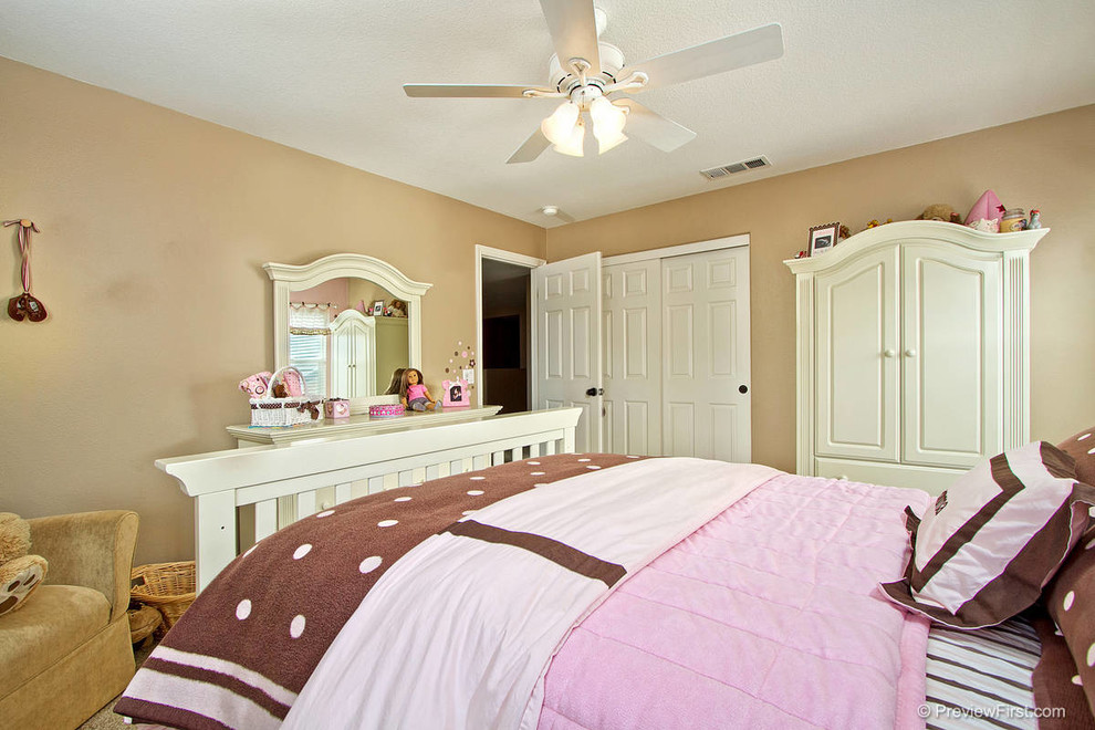 Example of a large transitional carpeted bedroom design in Orange County with pink walls and no fireplace