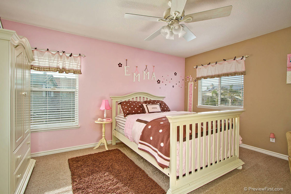 Example of a large transitional carpeted bedroom design in Orange County with pink walls and no fireplace