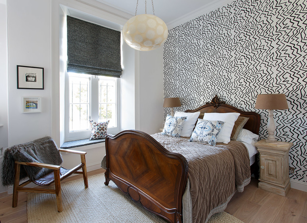 Contemporary bedroom in Edinburgh with multi-coloured walls, light hardwood flooring and beige floors.