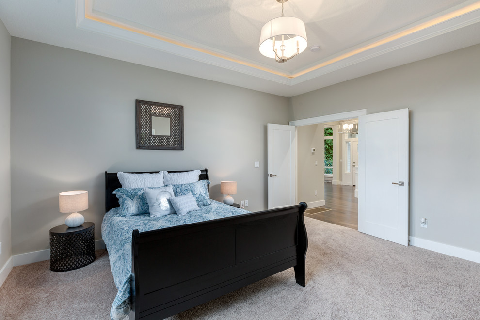 This is an example of a large contemporary master bedroom in Portland with grey walls, carpet and grey floors.