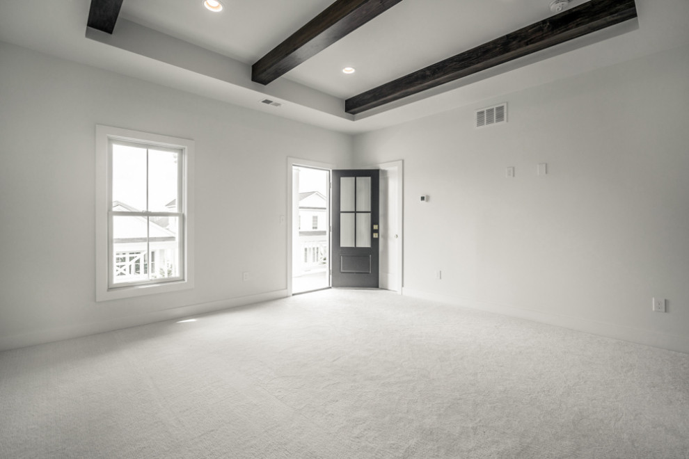 Modern master bedroom in Louisville with white walls, carpet, white floors and exposed beams.